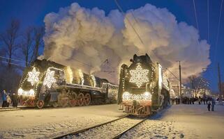 Russia, Peterhof, 07 January 2024. Two Santa Claus Trains leave the magically decorated building of the New Peterhof station, huge steam clubs, many people, incredible lighting photo