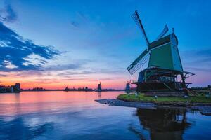 Windmills at famous tourist site Zaanse Schans in Holland with dramatic sky. Zaandam, Netherlands photo