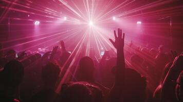 Crowd of people are at concert, with person in front of crowd holding their hand up. Atmosphere is energetic and lively, with everyone enjoying music and performance. photo