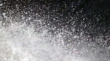 Mist rises in sunlight from waterfall, Close-up of water drops. Waste water droplets fall to the floor, steam from falling water, waterfall cascading, splashing falls water video