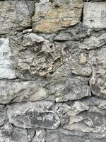 Background of gray stones with sharp edges, part of wall photo