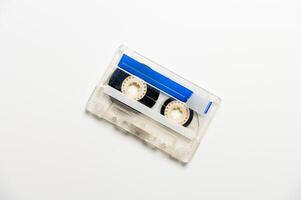 Audio cassette with black tape on a white background, top view. Template for inscription photo