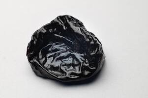 Dried plum, prunes on white background. Clipping Path. Shallow depth of field photo