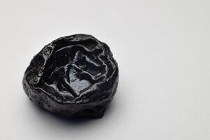 Prunes on a white background close-up. Dried plum fruit photo