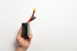 Lithium polymer battery with balancing and power connectors for powering fpv drones in a man's hand photo