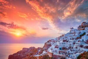 Sunset over Oia town on Santorini island in summer. Santorini, Greece photo