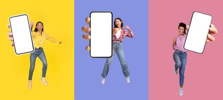 Happy multiethnic millennial three women jumping in the air with smartphones in their hands, showing phone blank empty screen, colorful background, set of photos, collage. Mobile app, online offer photo