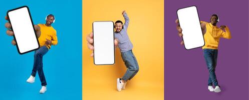 Overjoyed happy excited multiethnic millennials three guys with wireless headphones showing phones with white empty screen while jumping in the air over colorful background, collage. Mobile app photo