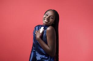 Stylish Young Black Woman In Sequin Dress Holding Smartphone And Looking At Camera, Happy Millennial African American Fashion Model Enjoying Mobile Communiation, Posing On Red Background, Copy Space photo