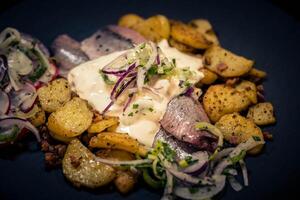 Fresh herb matjes with fried potatoes and Sylt sauce photo