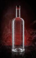 A wet bottle on a beautifully illuminated background. Smoke around a glass bottle. photo