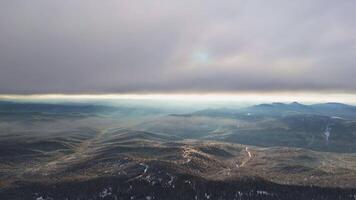 An aerial view of a mountain range under a cloudy sky video