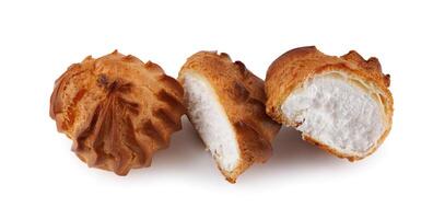 Cut in half and whole porophytole with white cream isolated on a white background. Eclair with cream. photo