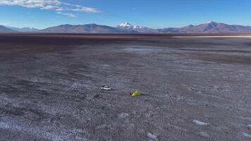 Desert landscape with vehicle and tent offers an adventurous view of uninhabited terrain video