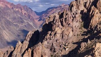 Dramatic mountain range scenery featuring rugged terrain and captivating shadows video