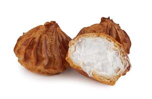 Profieroles with cream isolated on a white background. Whole and half profiteroles. photo