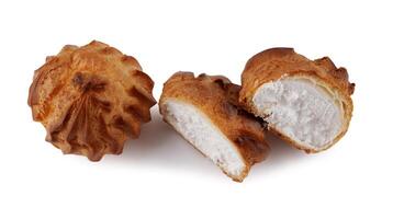 Cut in half and whole porophytole with white cream isolated on a white background. Eclair with cream. photo