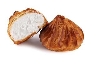 Profieroles with cream isolated on a white background. Whole and half profiteroles. photo