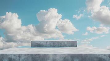 A minimalist concrete platform stands under a clear, bright sky filled with fluffy white clouds on a sunny day. photo