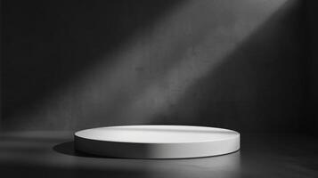 A round white platform is illuminated by a focused light beam in a dark, minimalist studio environment creating a stark contrast. photo