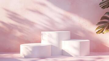 Three white pedestals are arranged against a pink wall with shadows and a tropical plant in the afternoon sunlight. photo