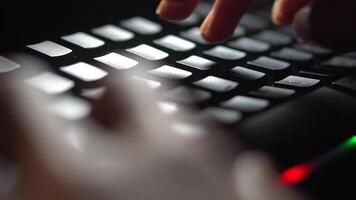Typing on backlit keyboard in dark video