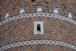 Ciechanow, Poland - June 8th, 2024 - Round tower with decorational pattern at Castle of the Masovian Dukes photo