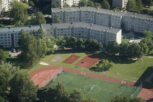 Vilnius, Lithuania - September 4th 2023 - Aerial view on soccer field and residential buildings from TV tower photo
