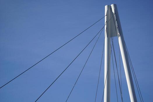 Cable-stayed bridge and cloudless sky - view from below photo