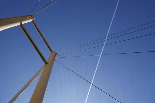 Cable-stayed bridge and cloudless sky - view from below photo