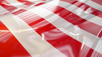 The tape features a smooth glossy surface that reflects light in different directions intensifying the bold red and white stripes that make up its distinctive pattern photo