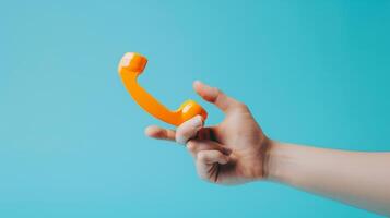A hand reaching out to the image of a phone with the hotline number illustrating accessibility and ease of us photo