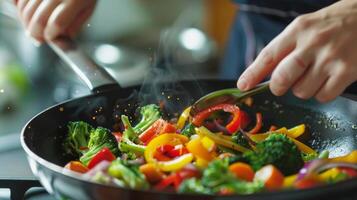 A person adding colorful vegetables to a stirfry illustrating the importance of a diverse range of nutrients for brain health photo