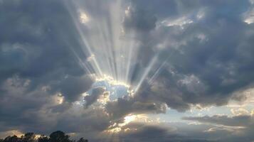 A cloudy sky with the sun peeking through representing the power of positive thinking on a gloomy day photo