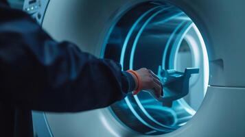 A technician adjusting the settings on the MRI machine before the scan begins photo