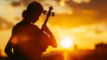 A silhouetted figure of a person playing a musical instrument against a sunset sky symbolizing the power of music to improve cognitive function photo
