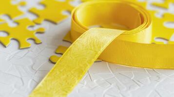 A yellow ribbon with a puzzle piece pattern representing the complexity of the brain and the need for more research photo