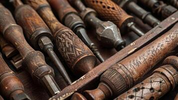 A grouping of antique hand drills some with intricate handcarved handles showcases the ingenuity and creativity of early construction workers photo