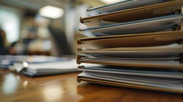 A stack of folders and paperwork tered on the table as contractors gather their documents for submission photo