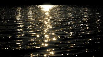 As darkness falls the moons glints on the water provide the only source of light creating a mysterious atmosphere photo