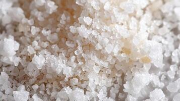The granular salt appears crumbly and fragile with some granules breaking off in irregular pieces photo
