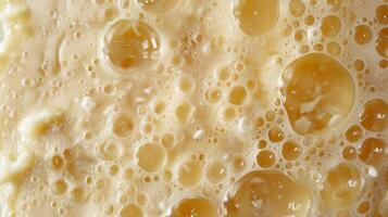 The top layer of a candle with tiny air bubbles creating a bumpy and uneven texture photo