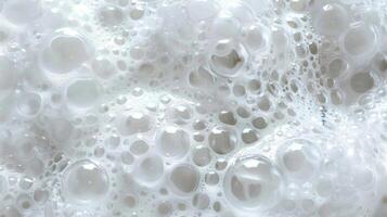 A topdown view of a dense and fluffy mass of bubbles resembling a soft white cloud and dotted with tiny droplets of water photo