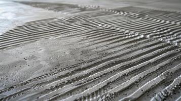 A closer look reveals an intricate network of overlapping lines and ridges on the concrete floor adding depth and dimension to its roughness photo