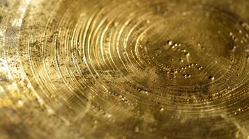 A smooth shiny brass surface now dulled and discolored by time revealing delicate lines and crevices where the metal once gleamed photo