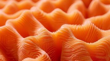 A closeup of bright orange foam padding appearing rough and spongy with visible creases and wrinkles photo