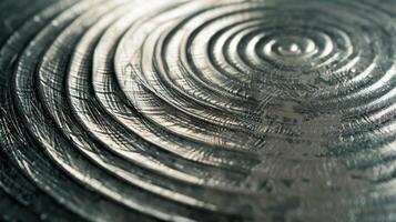 The smooth cool metal surface reveals faint circular patterns a result of the polishing process photo