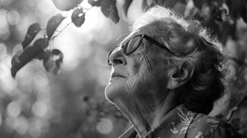 A visually impaired person listening to the rustling leaves and chirping birds in a sensory garden photo