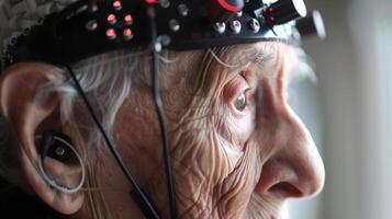 An image of an elderly person wearing a device on their head that monitors brain activity and alerts for signs of cognitive decline photo