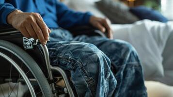 An image of a home health aide using proper lifting techniques to assist a client with paralysis in transferring from bed to wheelchair photo
